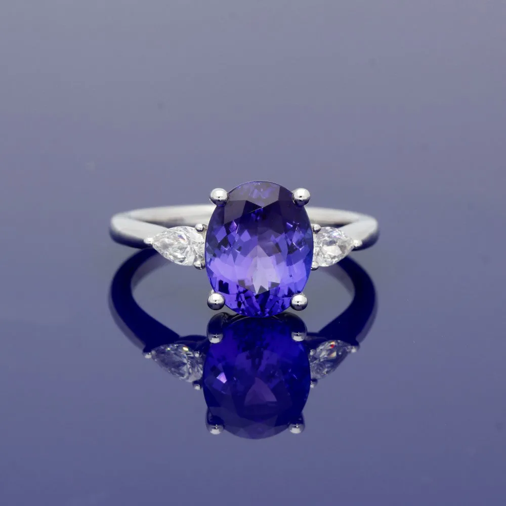 18ct White Gold Trilogy Ring with 3ct Tanzanite and Pear Shape Diamond Shoulders