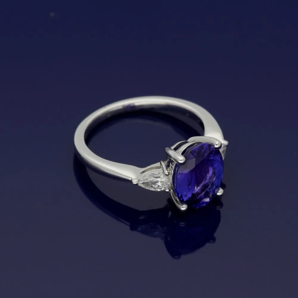 18ct White Gold Trilogy Ring with 3ct Tanzanite and Pear Shape Diamond Shoulders